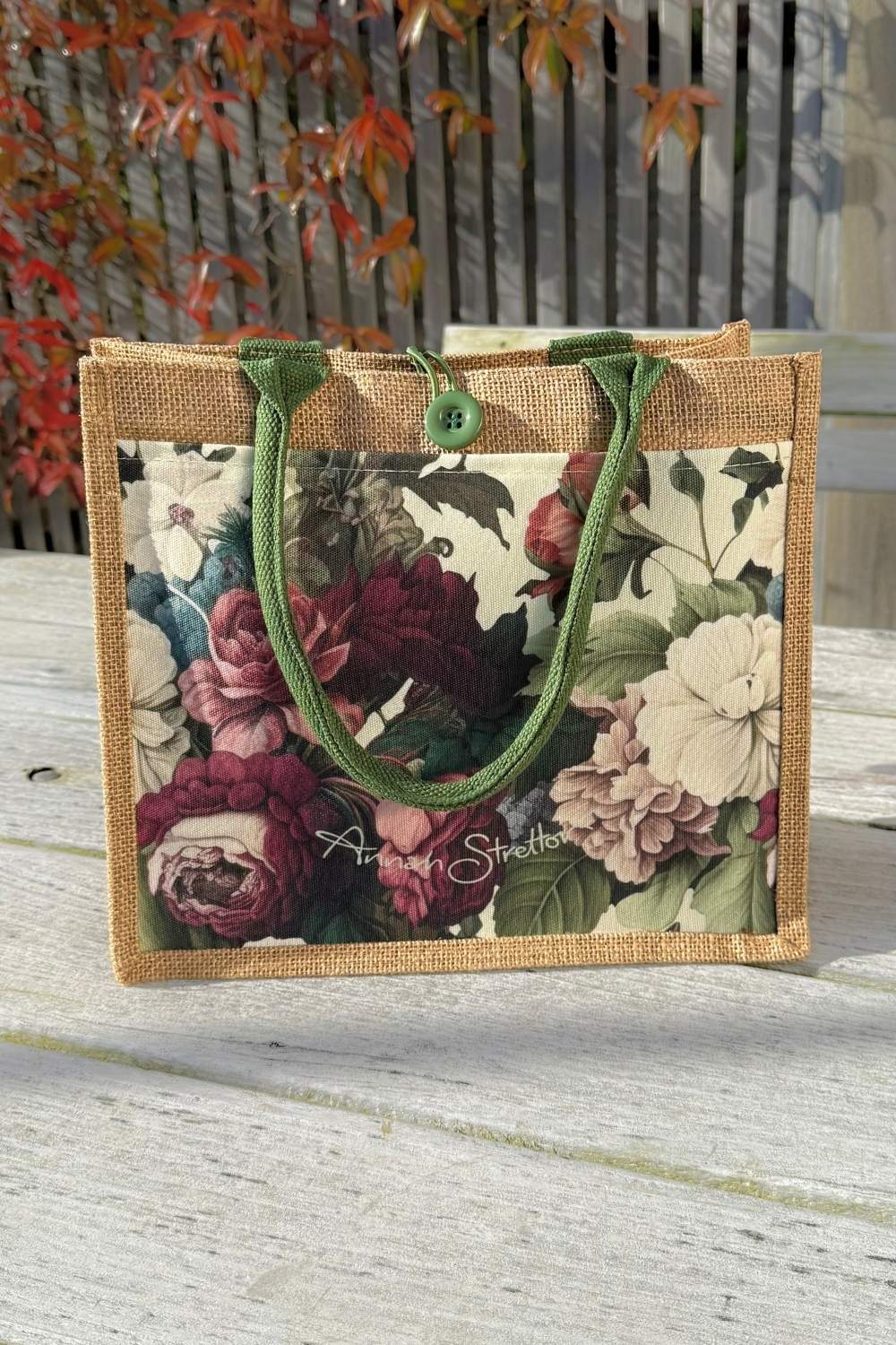 J'adore Roses mini jute bag shown from the front with the button loop closure