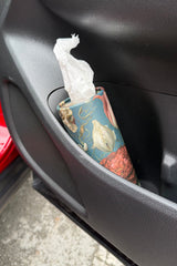 Tulip Party floral tissue cylinder sitting in a car cup holder within easy reach