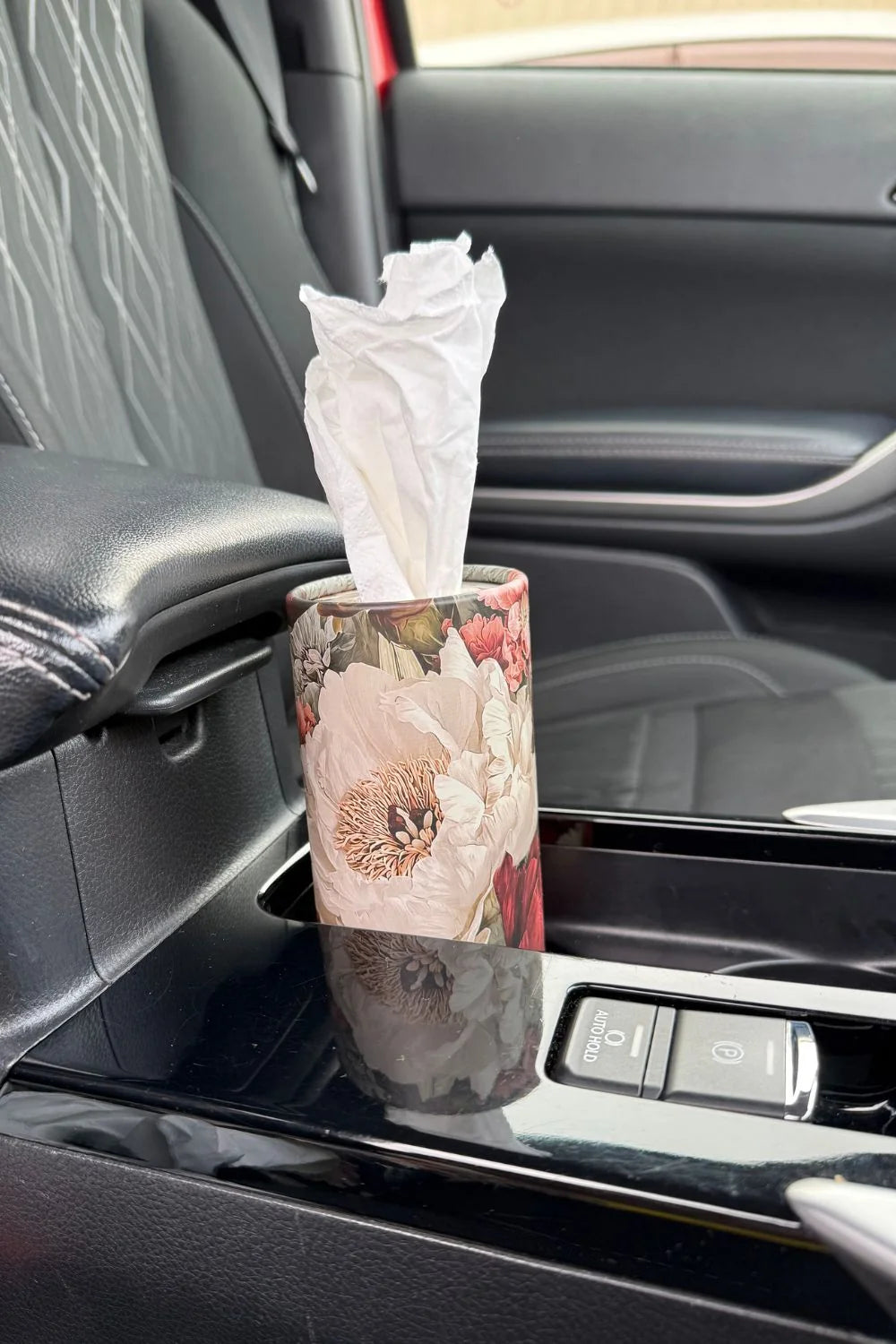 Floral tissue cylinder sitting in a car cup holder within easy reach