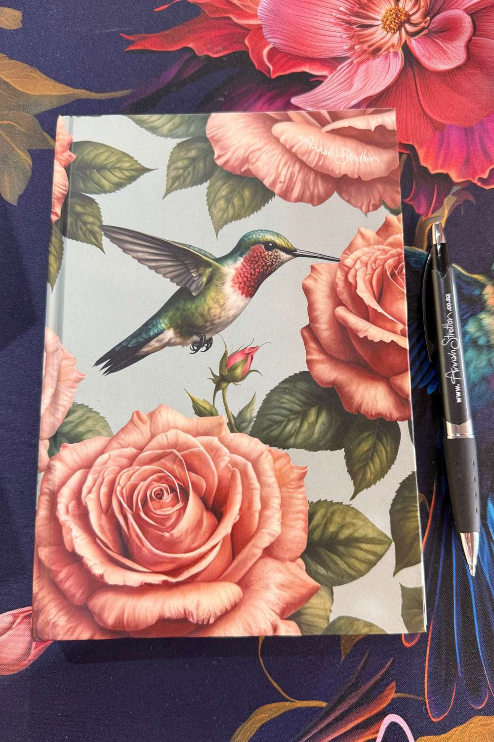 Close up of the pink rose and hummingbird print on the A5 notebook cover
