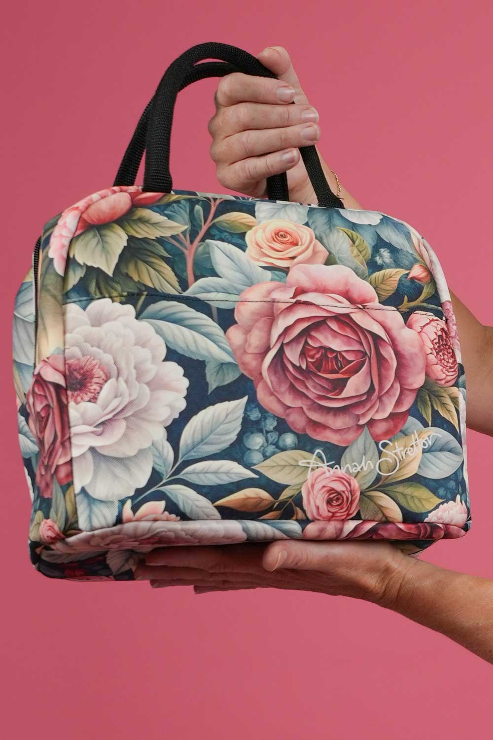 Annah Stretton Spring Serenade insulated cosmetic and travel bag held by the double top handles