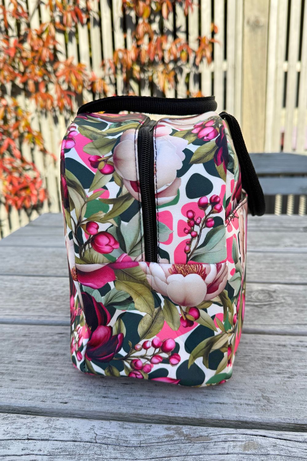 Side view of the Crimson Grace insulated travel bag showing the external pocket