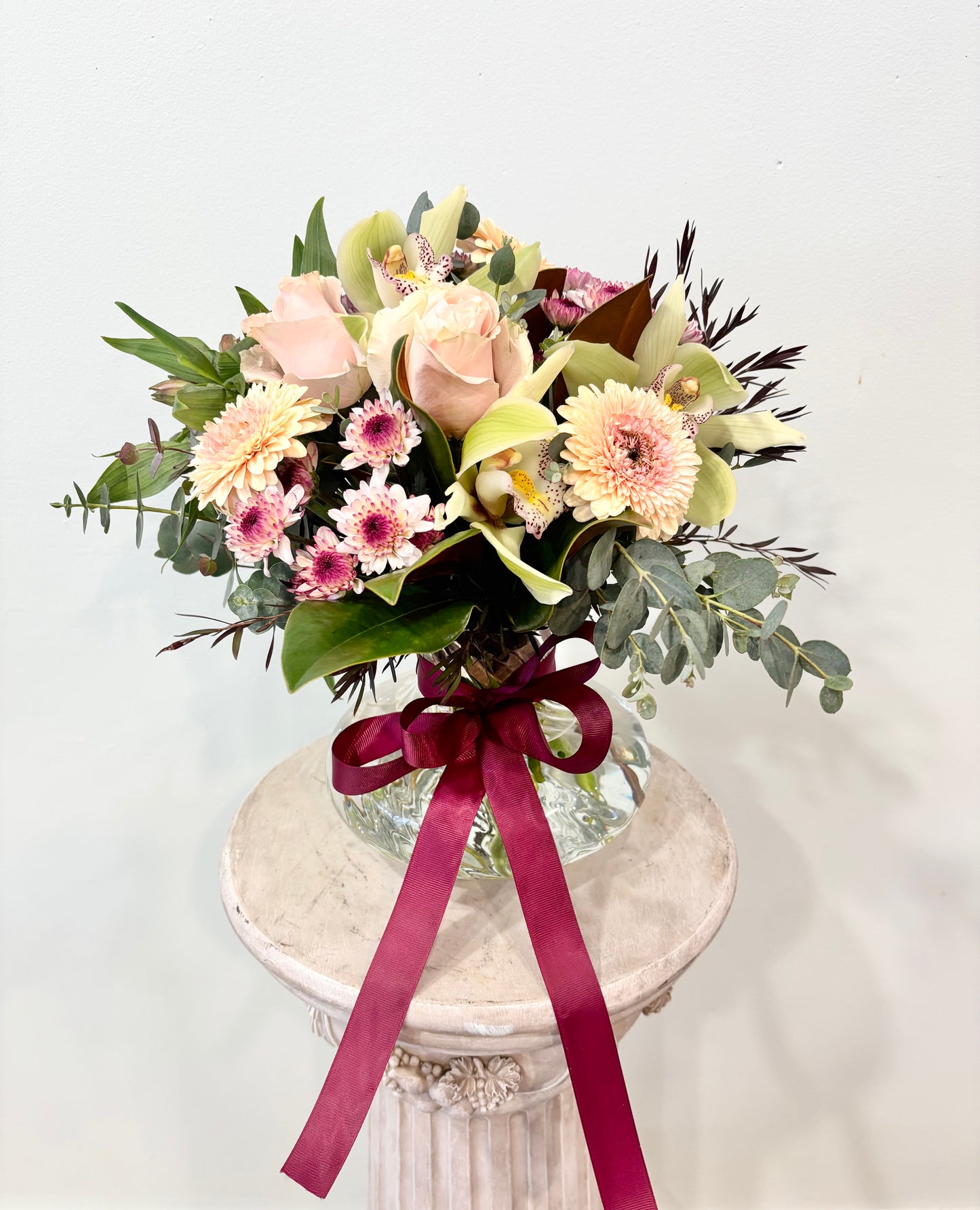 seasonal flowers arranged in a spiral vase