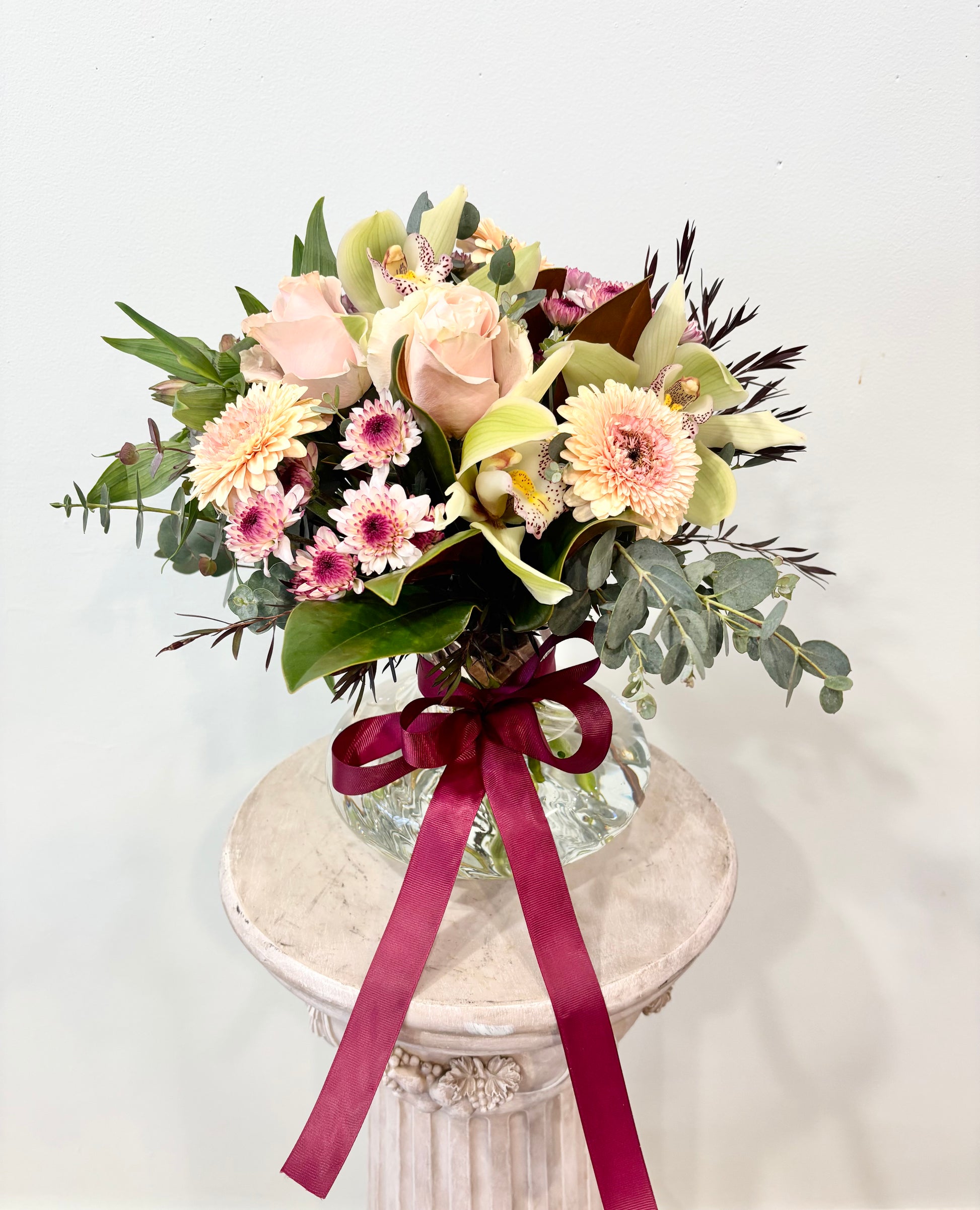 seasonal flowers arranged in a spiral vase
