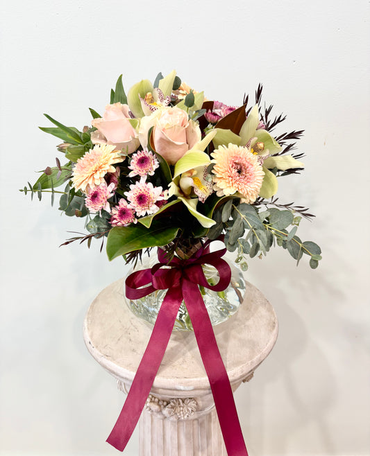 seasonal flowers arranged in a spiral vase